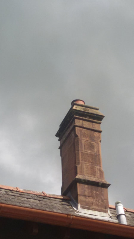 the view of a chimney pot on a stack