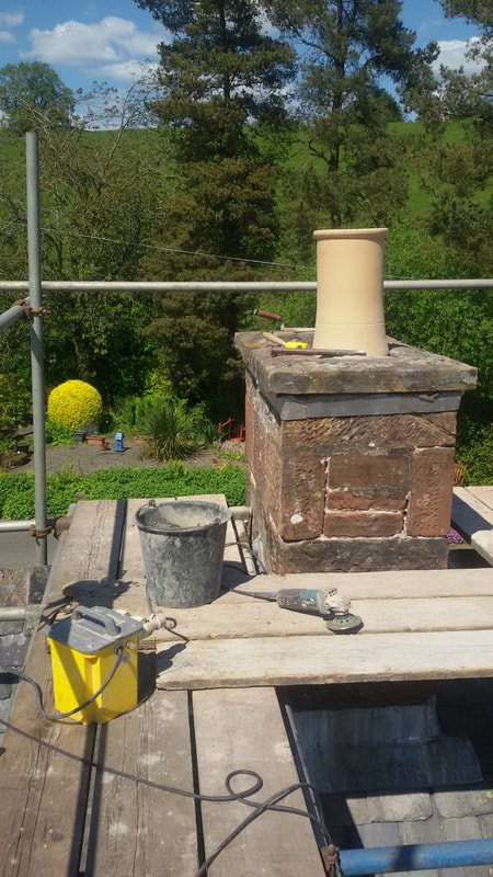 a view of the tools on the roof next to the chimney to be repaired
