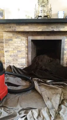 a loot of soot from a swept chimney having a hoover ready